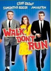 Movie poster of "Walk, Don't Run" featuring three individuals walking, with Cary Grant, Samantha Eggar, and Jim Hutton listed at the top.